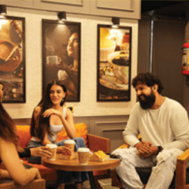 A group of people having a conversation over a cup of tea